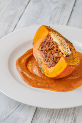 Portion of baked Hokkaido pumpkin with beef, tomato sauce, mozzarella cheese