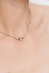 Silver Heart Pendant Necklace on Woman&rsquo;s Neck