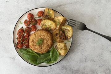 Baked cod fishcake with potatoes, victoria cherry vine tomatoes and fresh spinach.