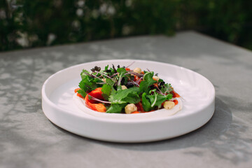 Plated salad with greens, chickpeas, and bell pepper
