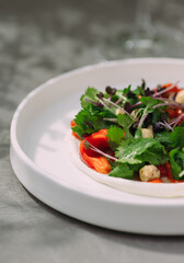 Fresh gourmet salad with greens and red peppers