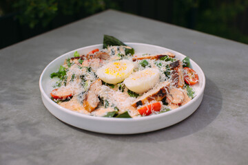 Fresh caesar salad with chicken, eggs, and cheese
