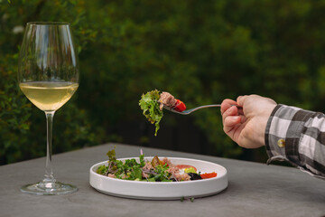 Enjoying a fresh tuna salad and white wine outdoors