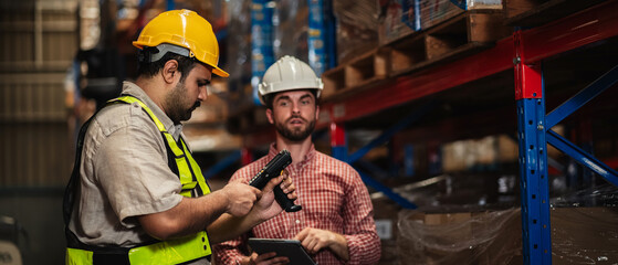 Warehouse workers and manager in reflective vests inspecting inventory, using digital tablet for...