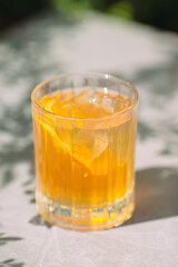 Refreshing summer drink with orange and ice