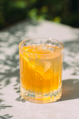 Refreshing iced drink with orange slices and ice