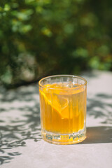 Refreshing orange beverage with citrus slice enjoying sun