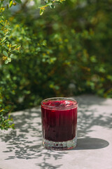 Refreshing red juice on a table outdoors