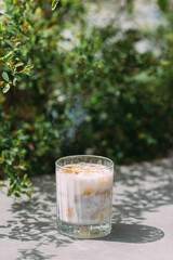 Iced coffee drink with milk and caramel outdoors