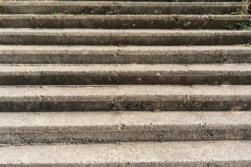 Old concrete steps with wear and plants. This photo represents the concept of decay and urban nature interaction.