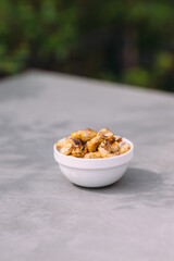 Eating a bowl of crunchy cashews as a healthy snack