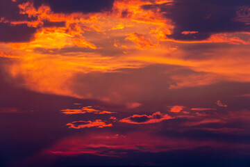 Deep orange sunset with backlit clouds