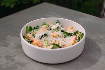Bowl of fresh shrimp salad with parmesan cheese