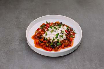 Ratatouille dish with burrata cheese and microgreens