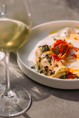 Savory pancakes with sauce and white wine