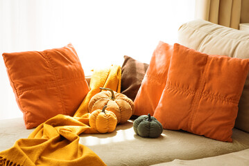 Autumnal living room decor with corduroy pumpkins and cozy pillows.