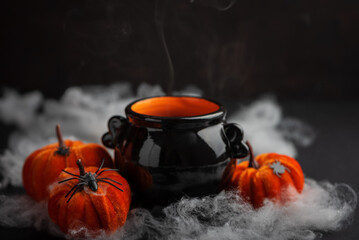 Halloween Candle in Cauldron with Pumpkins and Fog
