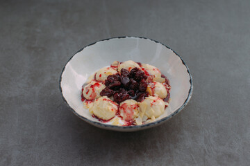 Cheese dumplings with stewed cherries and almonds