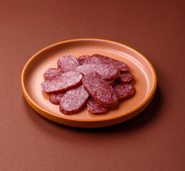 Sliced salami sausage, smoked meat as a delicacy for the table. Salami sausage