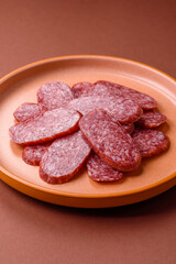 Sliced salami sausage, smoked meat as a delicacy for the table. Salami sausage
