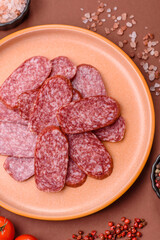 Sliced salami sausage, smoked meat as a delicacy for the table. Salami sausage