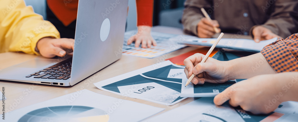 Aufkleber a diverse team engages in a collaborative meeting at a modern workspace, surrounded by charts and de