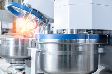 Puff pastry dough mixing machine in confectionery production line with sunlight, food industry factory.