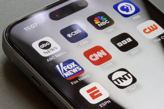 Portland, OR, USA - Sep 23, 2025: Assorted apps developed by TV networks, including the Big Three in the United States (ABC, CBS, and NBC) and public broadcaster PBS, are seen on an iPhone.