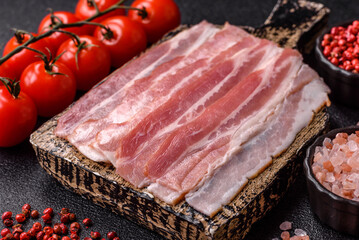 Raw or smoked pork bacon slices or strips as a breakfast ingredient. Raw bacon