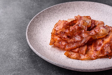 Fried pork bacon slices or strips as a breakfast ingredient. Fried bacon