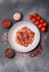 Fried pork bacon slices or strips as a breakfast ingredient. Fried bacon