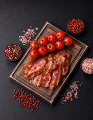Fried pork bacon slices or strips as a breakfast ingredient. Fried bacon