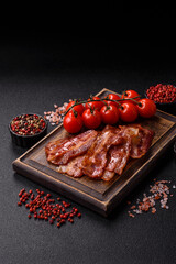 Fried pork bacon slices or strips as a breakfast ingredient. Fried bacon