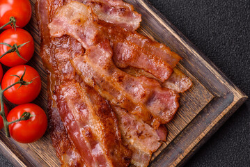 Fried pork bacon slices or strips as a breakfast ingredient. Fried bacon
