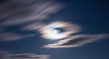 Abstract motion blur of moon and clouds at night.