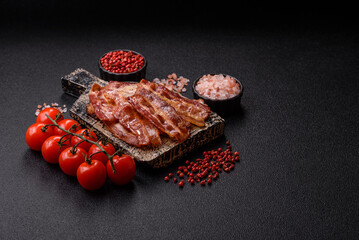 Fried pork bacon slices or strips as a breakfast ingredient. Fried bacon