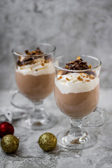 Holiday chocolate mousse with whipped cream and festive decorations