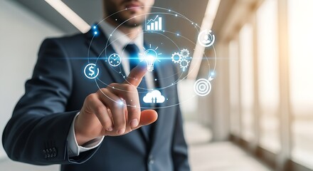Businessman interacting with digital interface showing business and technology icons on screen