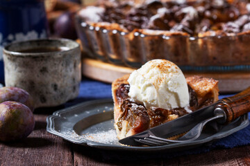 German plum cake with cinnamon, served with ice cream and coffee.