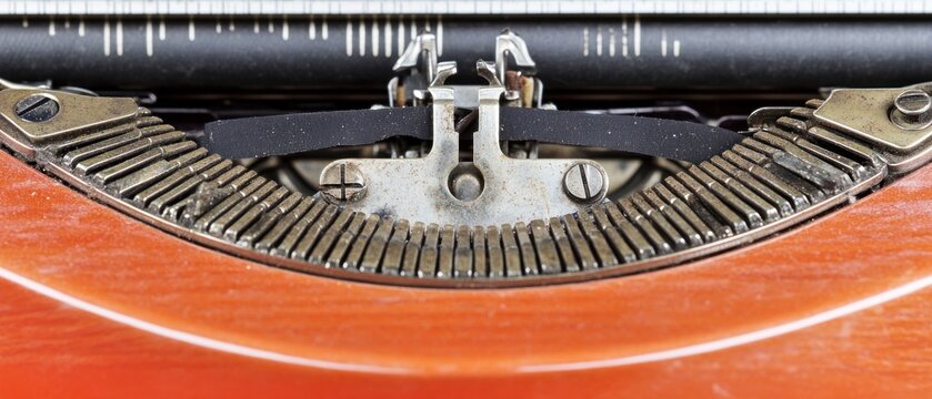 Vintage typewriter mechanism close up orange casing metal keys retro technology writing history