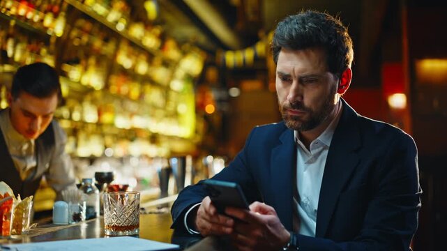 Frustrated guy holding smartphone in cafe bar closeup. Heartbroken man texting