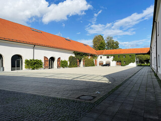 Courtyard of Furstenfeldbruck German estate with red tile roofs and ivy covered walls