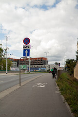 Bicycle lane beside busy street with no parking sign and new building under construction