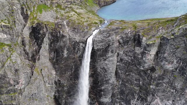 Epic waterfall in clouds zoom out drone shot, double waterfall of Mardalsfossen in Norway in 4K.