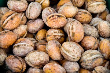 Fresh unshelled walnuts at the market.
