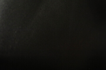 Minimalist dark black background with a very subtle grain texture.