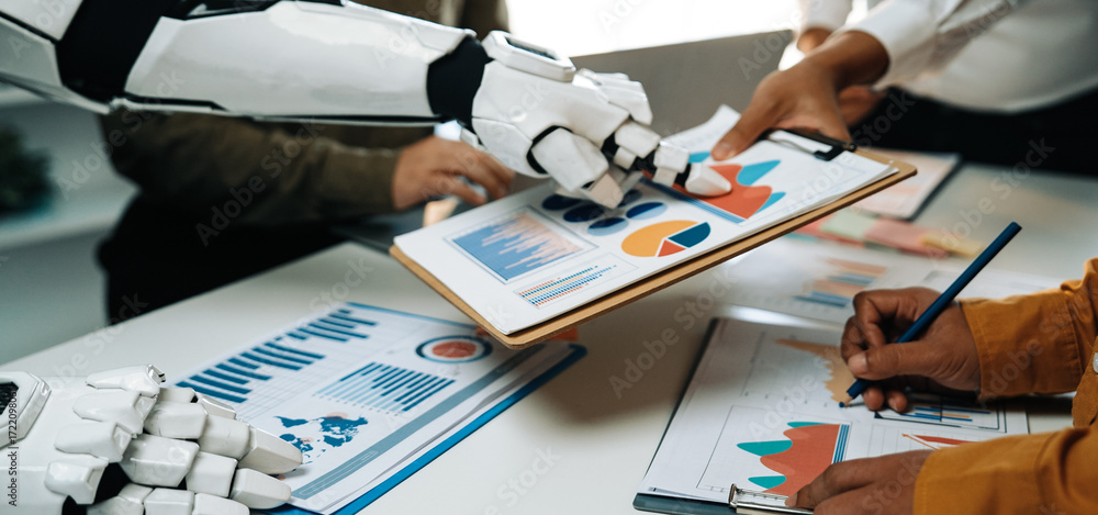 Poster a robot arm assists during a business meeting, showcasing charts and graphs to enhance team collabor