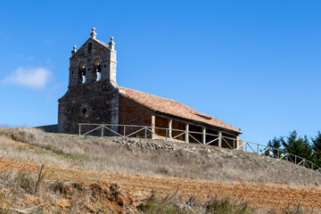 Fototapeta premium The Romanesque church of Saint Eugenia with its portico gallery on a hill in Dehesa de Romanos, Spain
