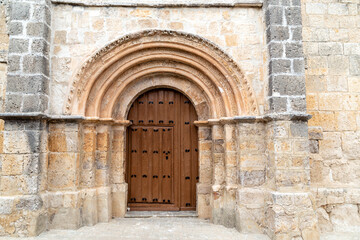 The Romanesque stone portal of the Church of Nuestra Señora de la Paz in Castrillo de Onielo, Spain