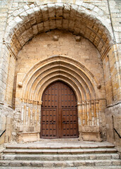 Fototapeta premium The Gothic portal of the historic Church of San Juan Bautista in Palenzuela, Palencia, Spain